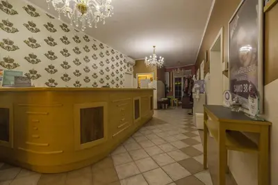 a store hallway with a counter and a chandelier at Room Oaza Miru in Maribor
