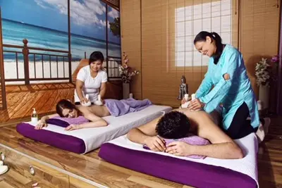 a group of people laying on beds in a room at Room Oaza Miru in Maribor