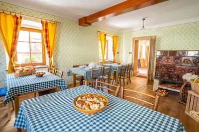 a room with two tables with blue and white tablecloths at Notranjska hiša - traditional country house, close to the world attraction Cerknica lake in Begunje pri Cerknici