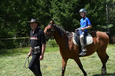 a man and a child riding on a horse with a man at Notranjska hiša - traditional country house, close to the world attraction Cerknica lake in Begunje pri Cerknici