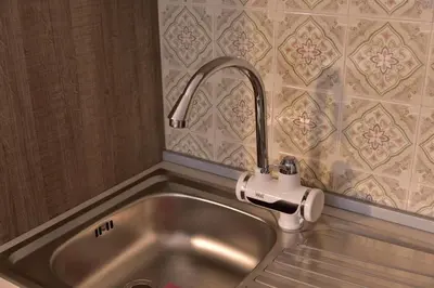 a stainless steel sink with a faucet in a kitchen at Primula Apartment in Blejska Dobrava