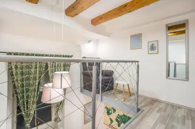 a room with a glass partition with a chair at Apartma N'Poznam Tobačna in Ljubljana