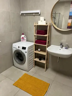a bathroom with a washing machine and a sink at DR7 Bled in Bled