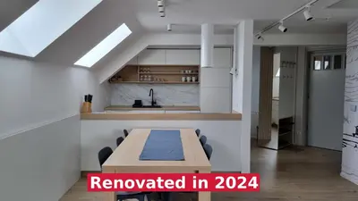 a room with a table and chairs and a kitchen at BledLake4U Apartment in Bled