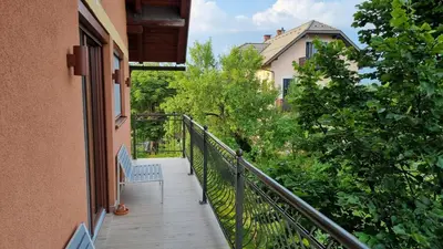 a balcony with a bench on the side of a building at BledLake4U Apartment in Bled