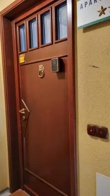 a brown door with a sign on it at BledLake4U Apartment in Bled