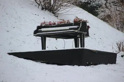 a piano sitting on top of a snow covered slope at BledLake4U Apartment in Bled