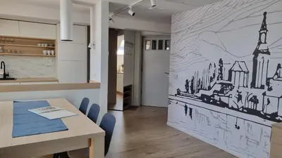 a dining room with a wall mural of a city at BledLake4U Apartment in Bled