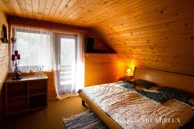a bedroom with a bed in a wooden room at Pet & Family Friendly House Viktorija - house near Golica with Triglav view in Jesenice