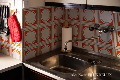 a kitchen sink with a red and white tiled wall at Pet & Family Friendly House Viktorija - house near Golica with Triglav view in Jesenice
