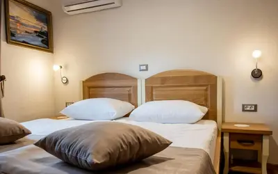 two beds with white pillows in a hotel room at Guest House Pri Cesarju in Kamnik