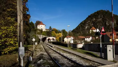 a train track with a building in the background at Guest House Pri Cesarju in Kamnik