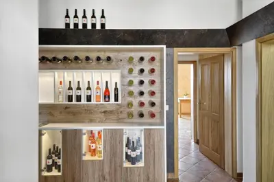 a wine cellar with a wall of wine bottles at Farm Stay Jarc Vineyard in Svečina