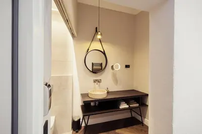 a bathroom with a sink and a mirror at Kollmann Rooms and Apartments in Ljubljana