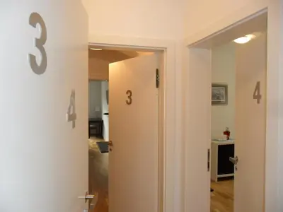 a hallway with a door with the number three on it at Kollmann Rooms and Apartments in Ljubljana