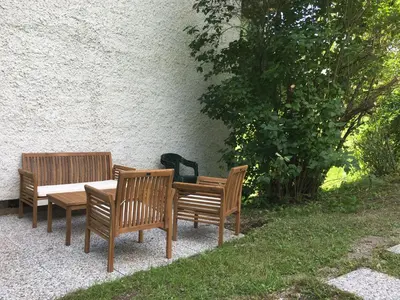 three wooden chairs and a wooden table and a table at Bed&Breakfast Anž'k in Bled
