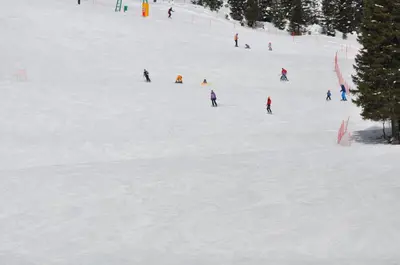 a group of people skiing down a snow covered slope at Bed&Breakfast Anž'k in Bled