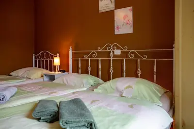 a bedroom with two beds with towels on them at Rooms Herman in Pivka