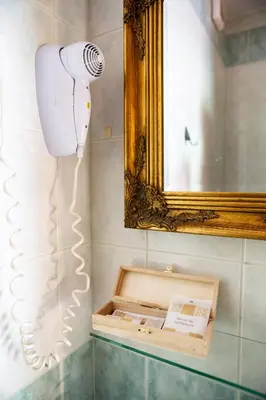 a hair dryer in a bathroom with a mirror at Rooms Herman in Pivka