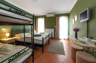 a bedroom with two bunk beds and a tv at Rooms Herman in Pivka