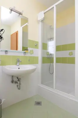 a bathroom with a sink and a shower at B&B Na Kluk in Idrija