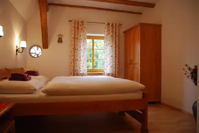a bedroom with two beds and a window at Farm Stay Rotovnik - Plesnik in Slovenj Gradec