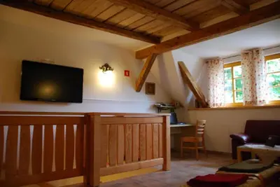 a living room with a flat screen tv on the wall at Farm Stay Rotovnik - Plesnik in Slovenj Gradec