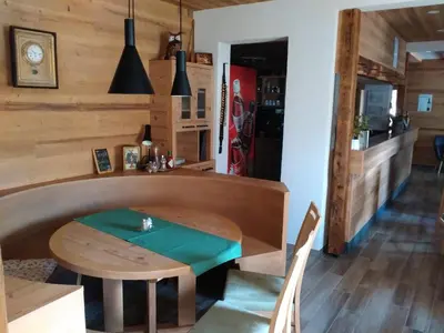 a wooden table and chairs in a room at Guesthouse Pri Zalogarju in Železniki