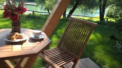a table with a plate of food and a cup of coffee at Holiday resort Bela krajina - Glamping and Mobile Homes in Metlika
