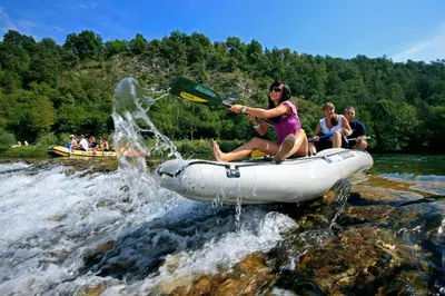 a group of people on a raft in the water at Holiday resort Bela krajina - Glamping and Mobile Homes in Metlika