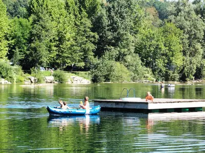 a group of people in a canoe on a lake at Holiday resort Bela krajina - Glamping and Mobile Homes in Metlika