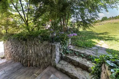 a stone wall with a statue on top of it at Apartments Jaka in Dolenjske Toplice