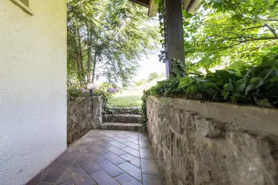 a walkway with a stone wall and a window at Apartments Jaka in Dolenjske Toplice