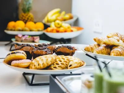 a buffet of different types of pastries on plates at Hotel Heritage in Ljubljana