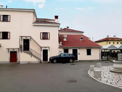 a car parked in a parking lot next to a building at Gostilna pri Dragici, gostilna s prenočišči, d.o.o. in Sežana