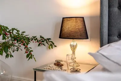 a lamp on a glass table next to a bed at Peterc Vineyard Estate in Kojsko