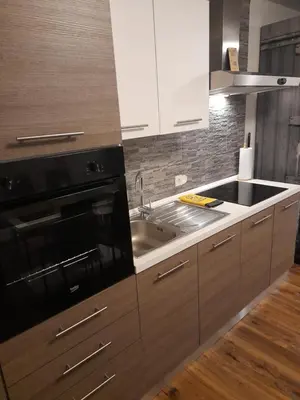 a kitchen with a sink and a stove at Honey Apartment Lendava in Lendava