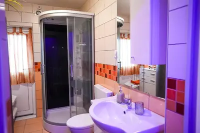 a bathroom with a sink and a shower and a toilet at Honey Apartment Lendava in Lendava