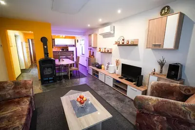 a living room with a couch and a table at Honey Apartment Lendava in Lendava