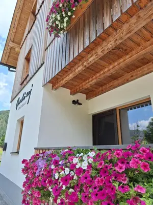 a house with flowers on the side of it at Apartments Gorski raj in Kranjska Gora