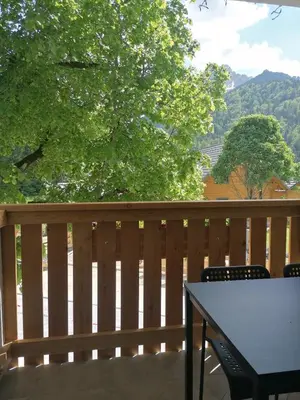 a deck with a table and chairs on a fence at Apartments Gorski raj in Kranjska Gora