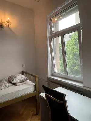 a small room with a bed and a window at Rooms Miklošičeva in Ljubljana