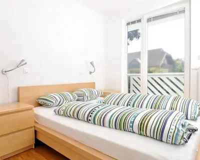 a bed with pillows on it with a window at Marvellous Face in Bled