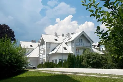 a white house with a windmill on the side of it at Marvellous Face in Bled