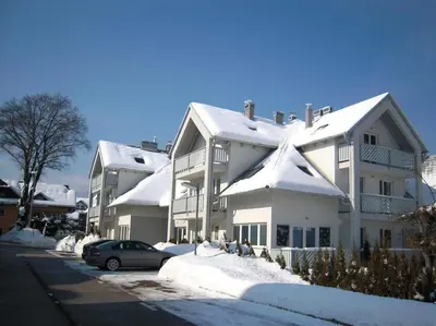 a snow covered house with a car parked in front of it at Marvellous Face in Bled