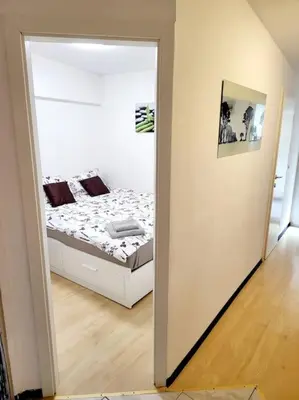 a bedroom with a bed and a large mirror at R.I.Š.-Rest in Šiška Duplex in Ljubljana