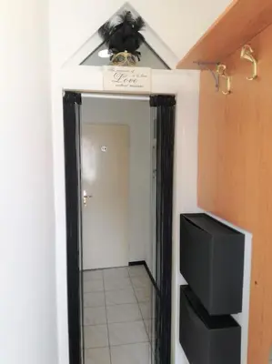 a hallway with a mirror and a tv in a room at R.I.Š.-Rest in Šiška Duplex in Ljubljana
