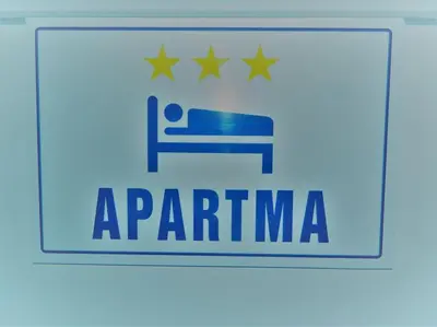 a logo for an airline with a bed and stars at R.I.Š.-Rest in Šiška Duplex in Ljubljana
