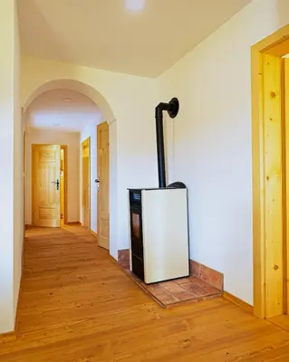 a living room with a tv in the corner of a room at Old Farm House Breg in Žirovnica