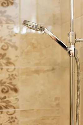 a shower with a shower head in a bathroom at Old Farm House Breg in Žirovnica
